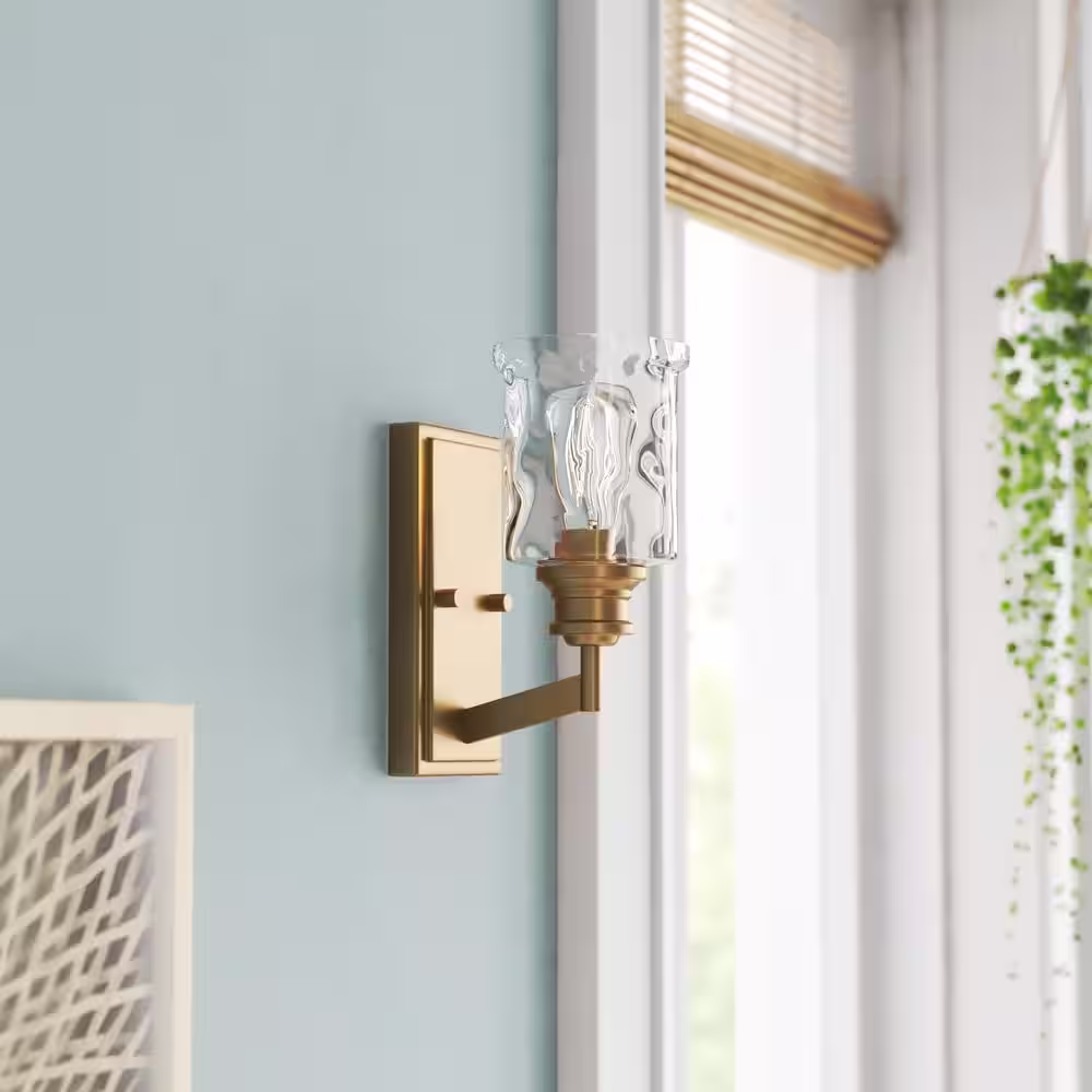 Designers Fountain Drake 5 in. 1-light Brushed Gold Modern Industrial indoor wall sconce with Clear Hammered Glass Shade