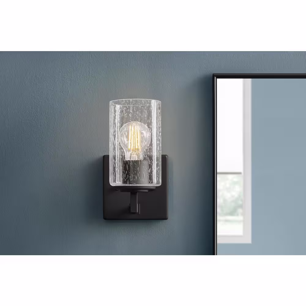 Home Decorators Collection Helenwood 1-Light Matte Black Wall Sconce with Clear Seeded Glass